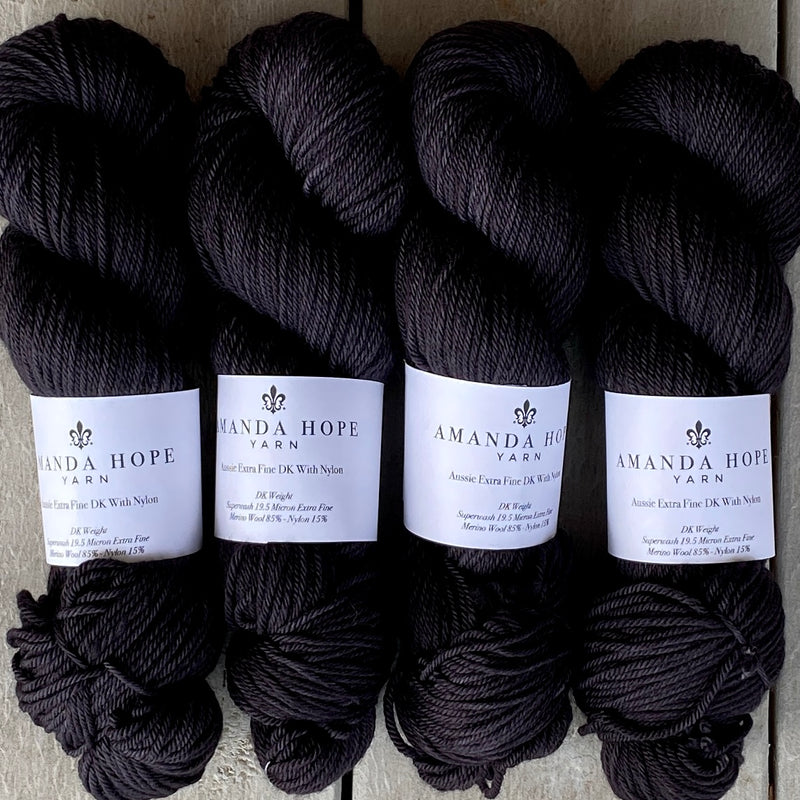 Three skeins of Amanda Hope Yarn's Noir, Aussie Extra Fine DK with Nylon.